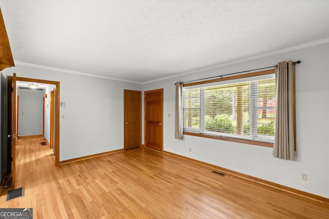 unfurnished bedroom featuring light hardwood / wood-style flooring and ornamental molding