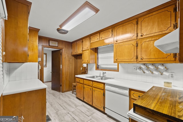 kitchen with light wood-type flooring, backsplash, extractor fan, sink, and dishwasher