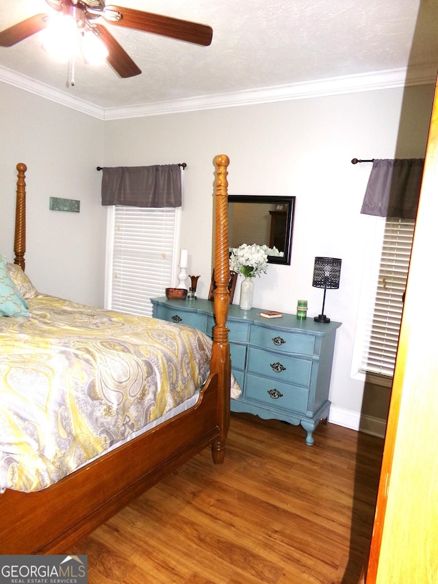 bedroom with ceiling fan, crown molding, hardwood / wood-style floors, and a textured ceiling