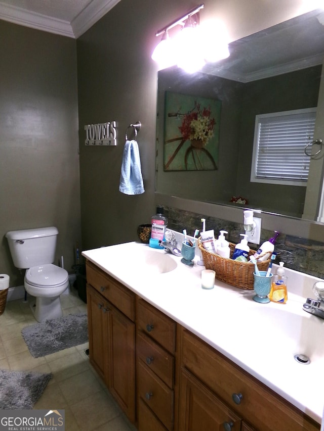 bathroom featuring vanity, toilet, and ornamental molding