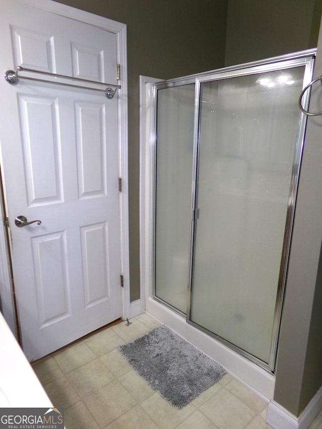 bathroom with a shower with shower door