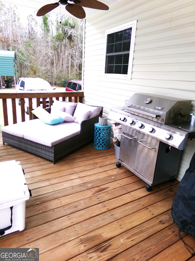 deck with grilling area and ceiling fan