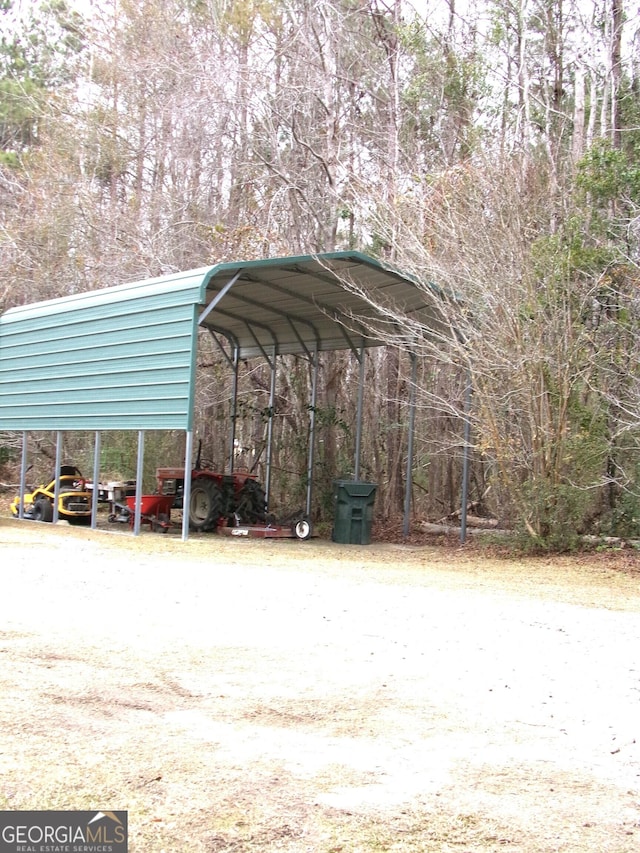 view of parking / parking lot featuring a carport