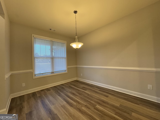 unfurnished room featuring dark wood-type flooring