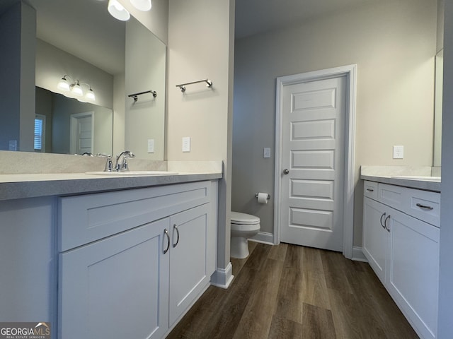 bathroom featuring hardwood / wood-style floors, vanity, and toilet