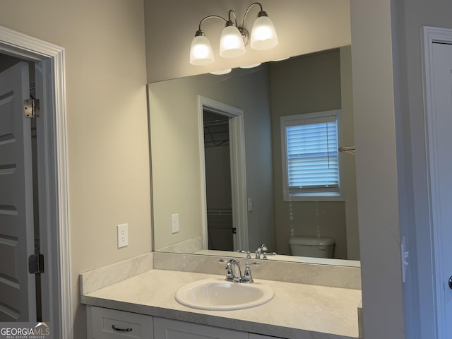 bathroom featuring vanity and toilet