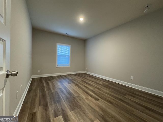 spare room with dark hardwood / wood-style flooring