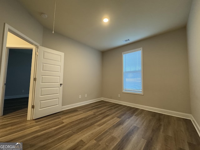 unfurnished room featuring dark hardwood / wood-style floors