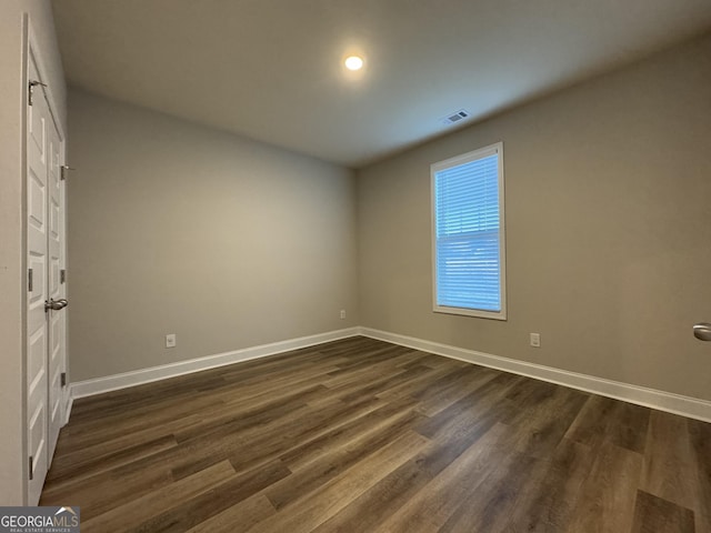 unfurnished bedroom featuring dark wood-type flooring