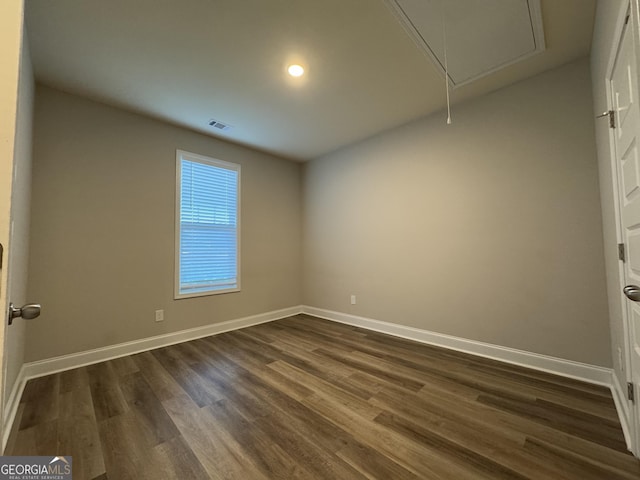 spare room featuring dark hardwood / wood-style floors