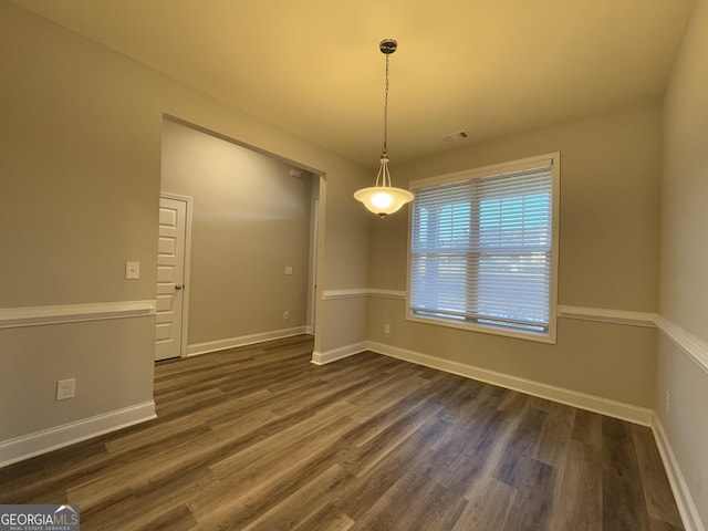 empty room featuring dark wood-type flooring