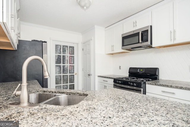 kitchen with white cabinets, light stone countertops, sink, and appliances with stainless steel finishes