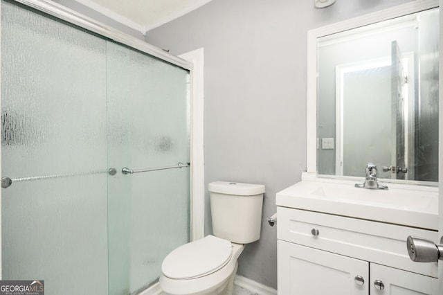 bathroom with vanity, a shower with shower door, and toilet