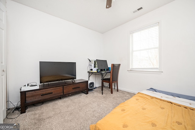 carpeted home office featuring ceiling fan