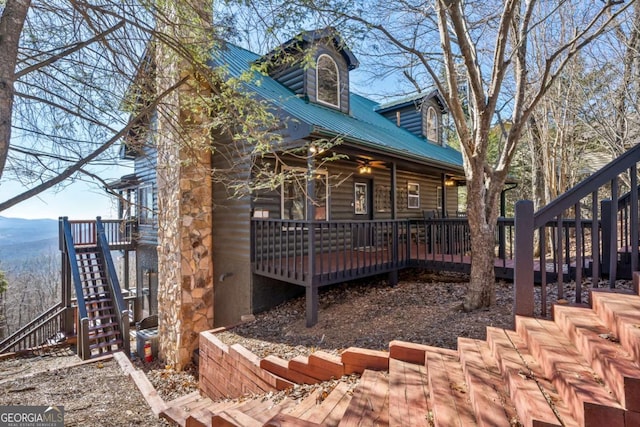 back of property with a deck with mountain view