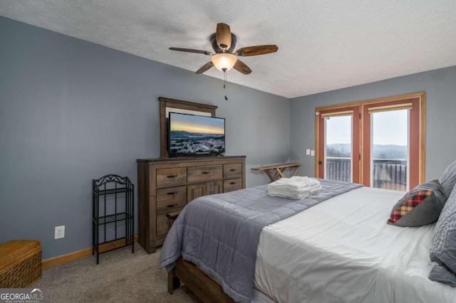 carpeted bedroom featuring ceiling fan, access to exterior, and a textured ceiling