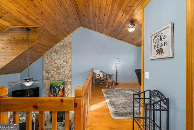 corridor featuring lofted ceiling, wood ceiling, and light hardwood / wood-style flooring