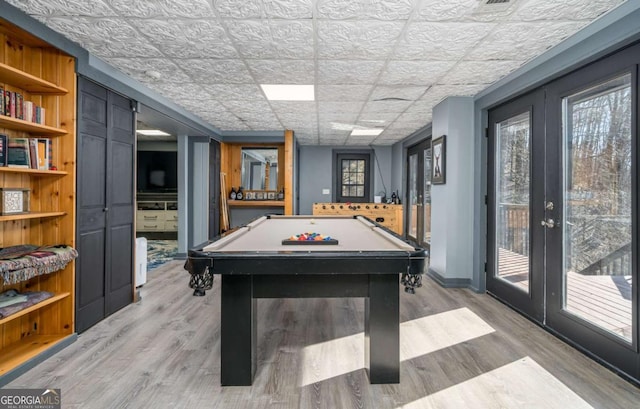 game room featuring light hardwood / wood-style floors, billiards, and french doors