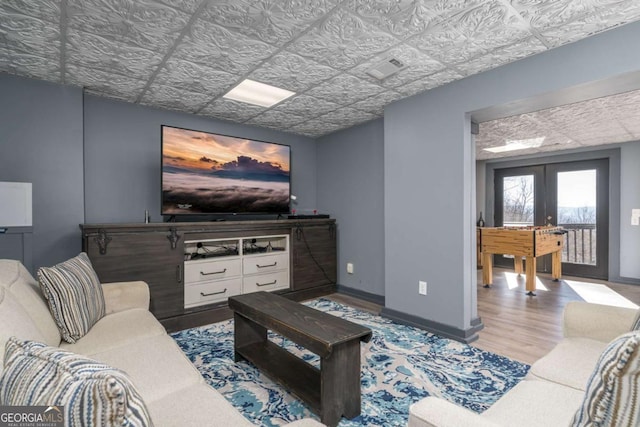 170 Walnut Rdg, Ellijay, GA 30536 - living room featuring wood finished floors, an ornate ceiling, french doors, and baseboards