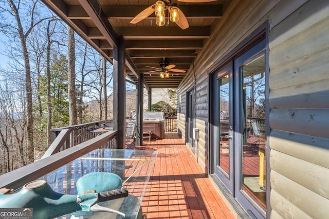 wooden deck with ceiling fan, a grill, and a hot tub