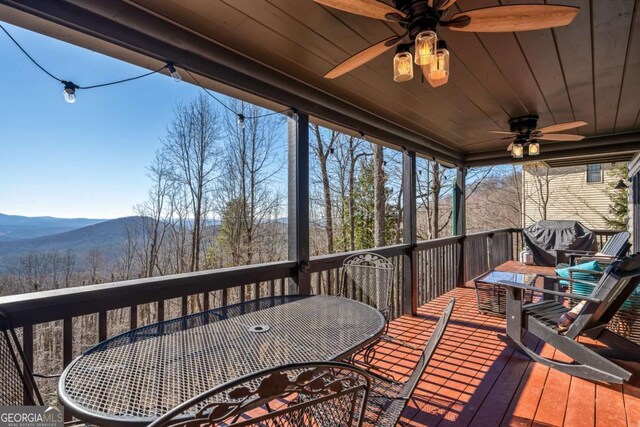 170 Walnut Rdg, Ellijay, GA 30536 - wooden deck with outdoor dining space, ceiling fan, and a mountain view
