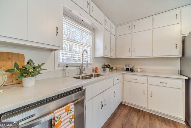 kitchen featuring stainless steel dishwasher, dark hardwood / wood-style floors, white cabinets, and sink