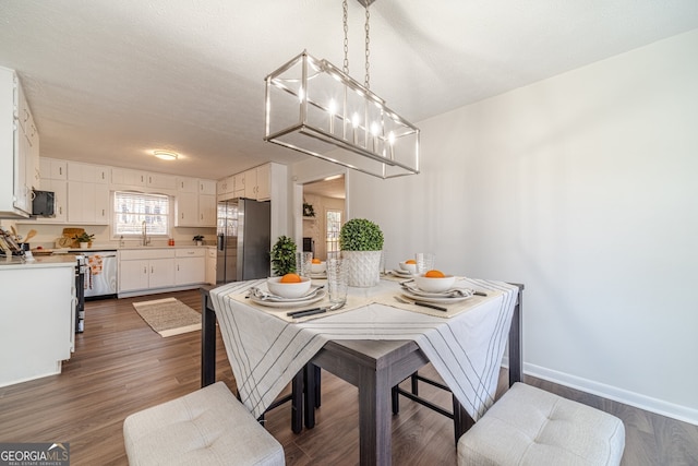 dining space with dark hardwood / wood-style floors