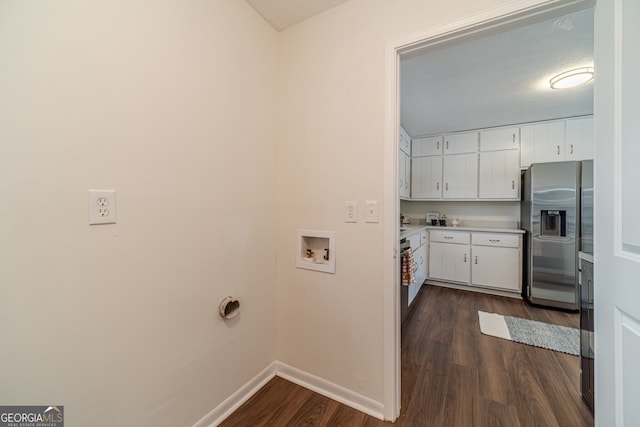 washroom featuring hookup for a washing machine, a textured ceiling, and dark wood-type flooring