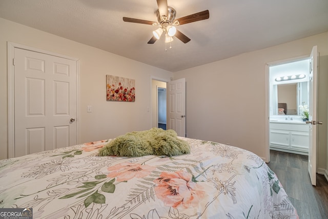 bedroom featuring connected bathroom, ceiling fan, dark hardwood / wood-style flooring, and sink