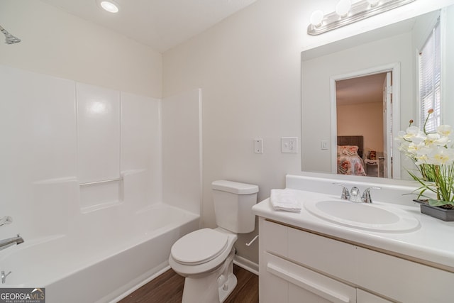 full bathroom featuring shower / bath combination, vanity, hardwood / wood-style flooring, and toilet