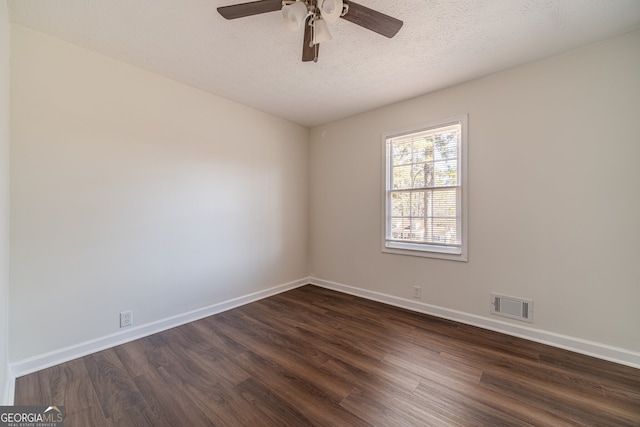 empty room with a textured ceiling, ceiling fan, and dark wood-type flooring