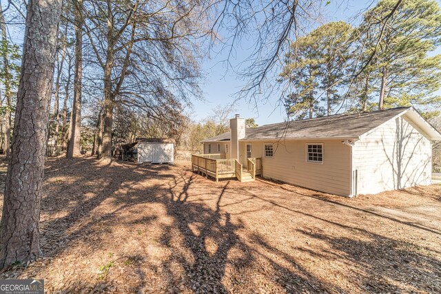 rear view of house with a wooden deck