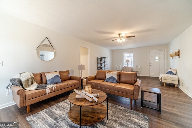 living room with ceiling fan and dark hardwood / wood-style floors