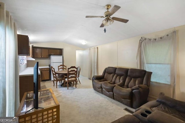 living room with light colored carpet, ceiling fan, and lofted ceiling