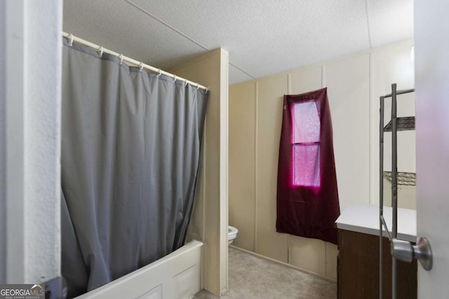 full bathroom with shower / tub combo, vanity, a textured ceiling, and toilet