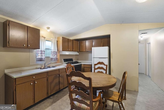 kitchen featuring white appliances, dark brown cabinetry, lofted ceiling, and sink