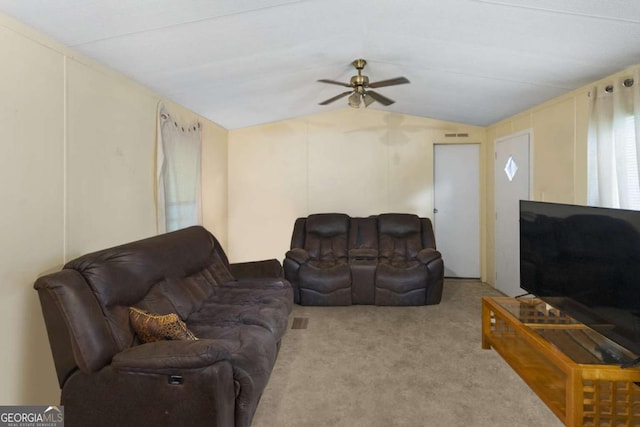 living room with ceiling fan, light colored carpet, and vaulted ceiling