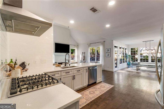 kitchen with stainless steel appliances, white cabinets, french doors, hanging light fixtures, and range hood