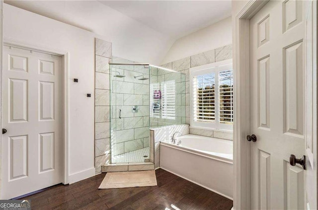 bathroom with vaulted ceiling, plus walk in shower, and wood-type flooring