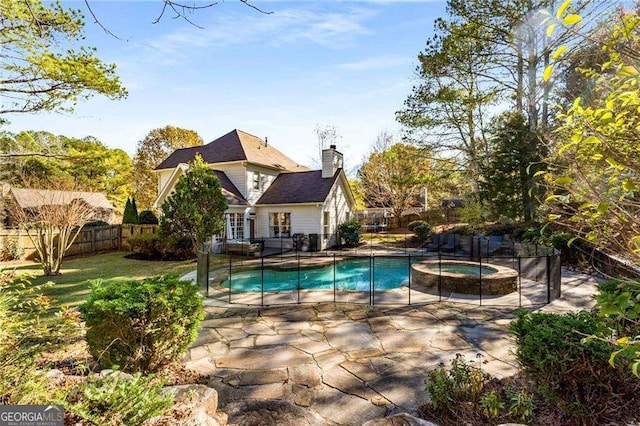 view of pool featuring a patio, french doors, and an in ground hot tub