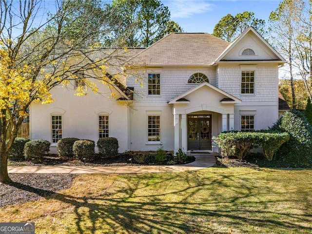 view of front of property with french doors and a front yard