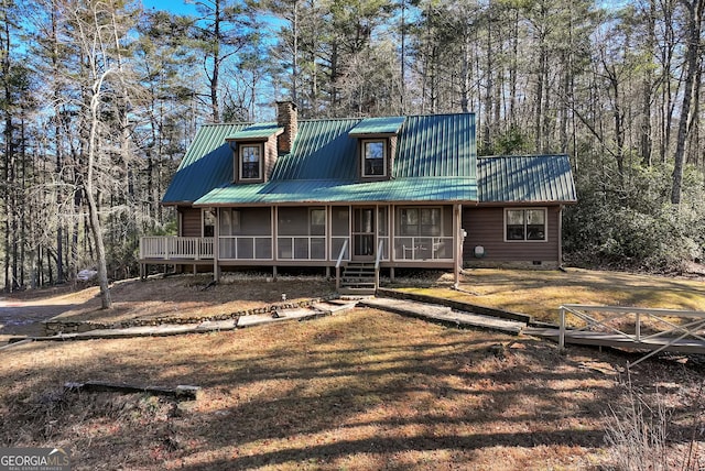 view of front of house featuring a front yard and a sunroom