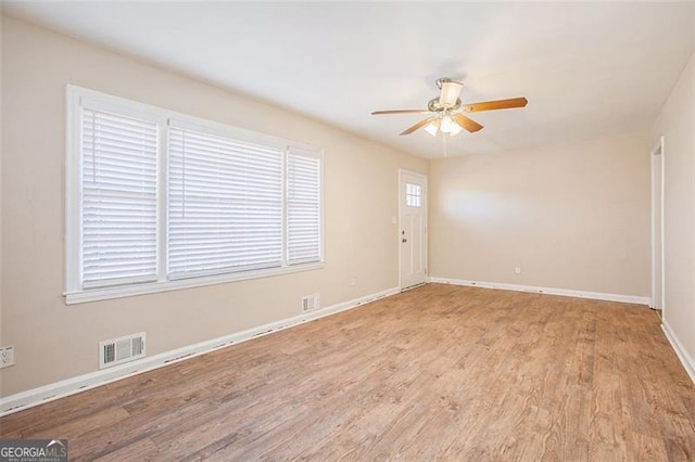 spare room featuring ceiling fan and light hardwood / wood-style flooring