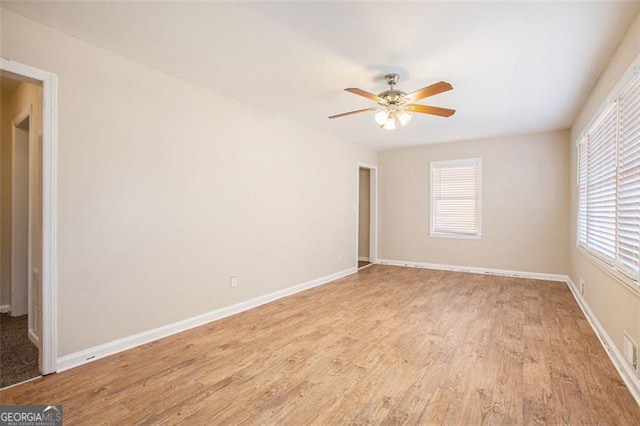 unfurnished room featuring light hardwood / wood-style floors, ceiling fan, and a healthy amount of sunlight