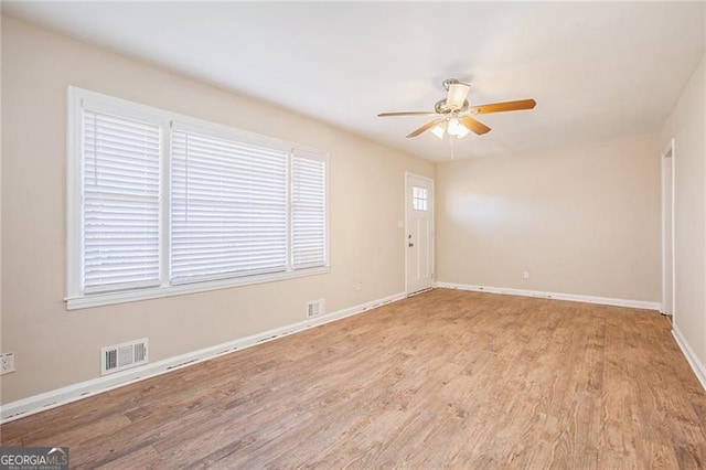 unfurnished room featuring ceiling fan, light hardwood / wood-style flooring, and a healthy amount of sunlight