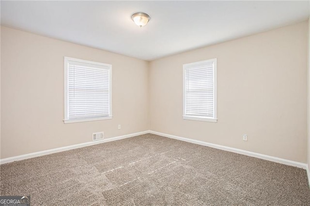 unfurnished room featuring carpet flooring