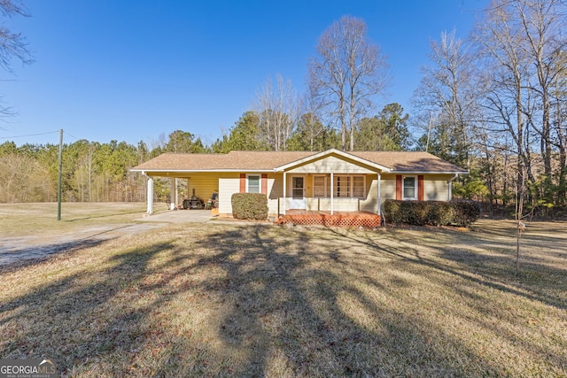 ranch-style house with covered porch, a carport, and a front yard