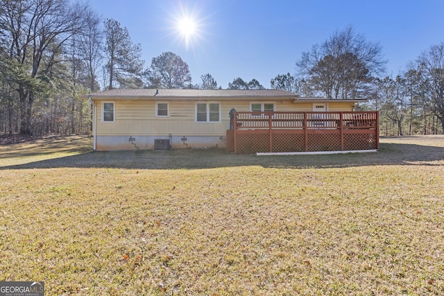 rear view of house with a lawn, central air condition unit, and a wooden deck