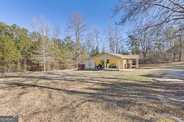 view of property exterior featuring a lawn and a porch