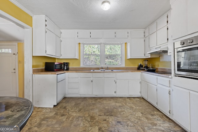 kitchen featuring white cabinetry and black appliances